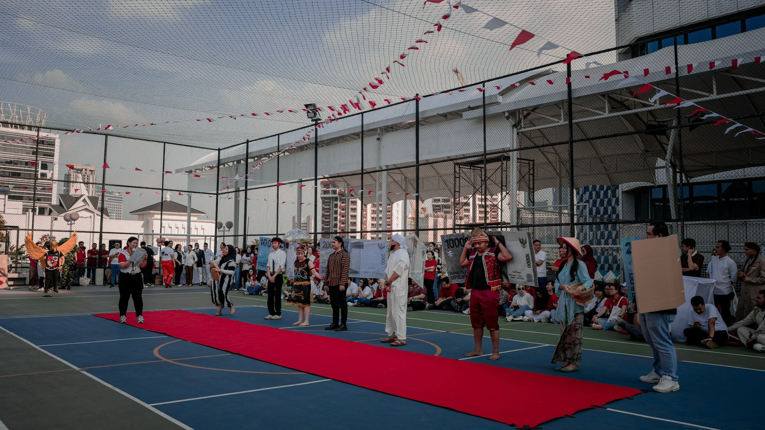 Crowd gathered along an outdoor red carpet at an event