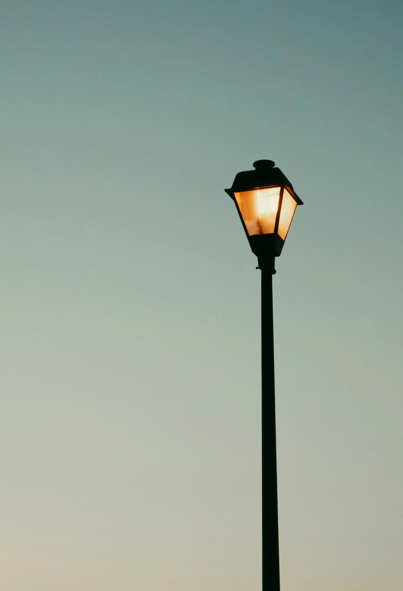 Glowing streetlight at dusk, a nostalgic symbol of Gen X childhood