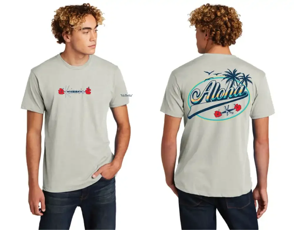 A young man with curly blond hair wearing a light gray T-shirt with Hawaiian-themed graphics, seen from the front and back. The front has the word 'Kaimana's' with small red flowers, and the back has the word 'Aloha' with palm trees, birds, and hibiscus flowers.