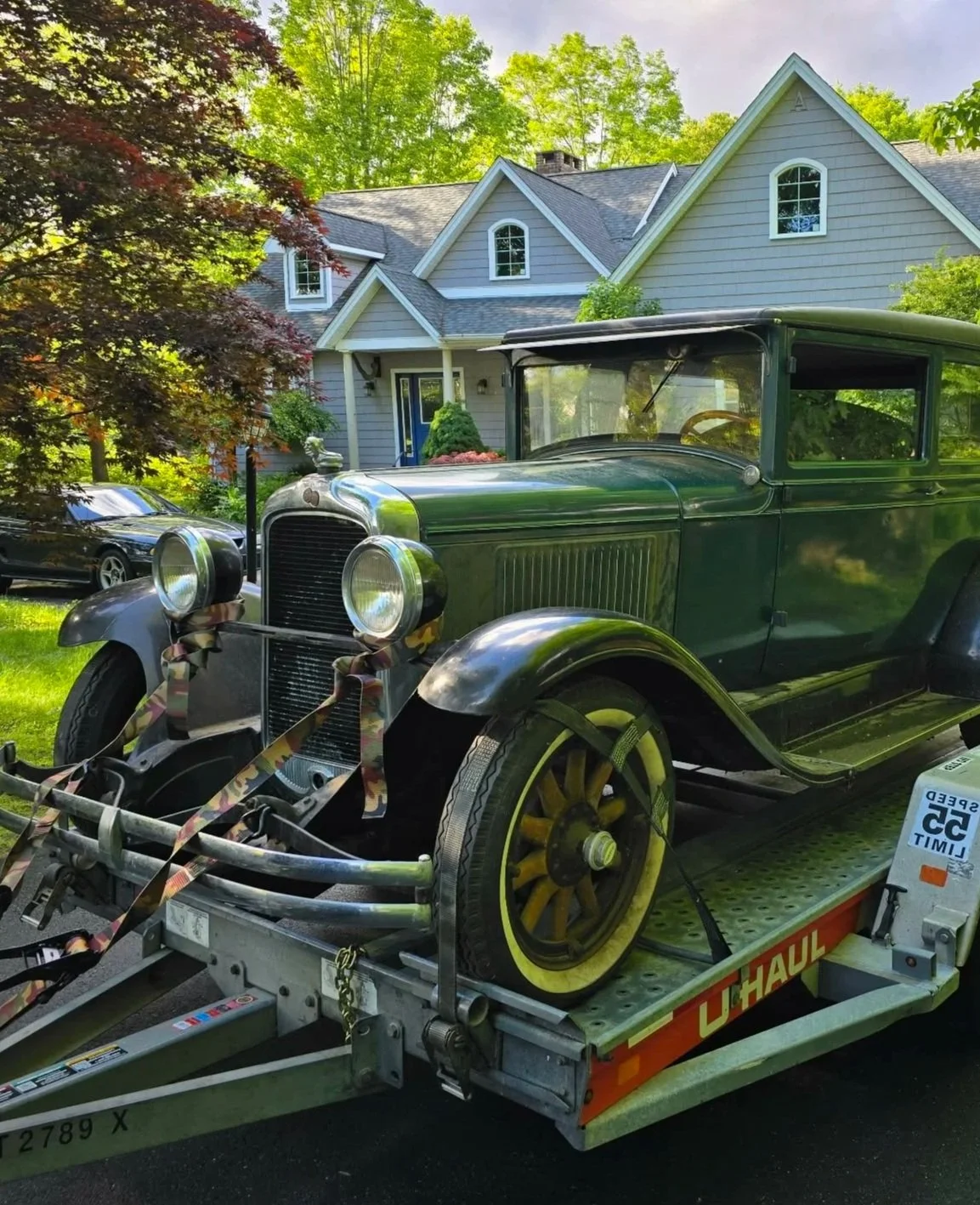 Antique automobile loaded onto a trailer during an East-Wing estate removal.