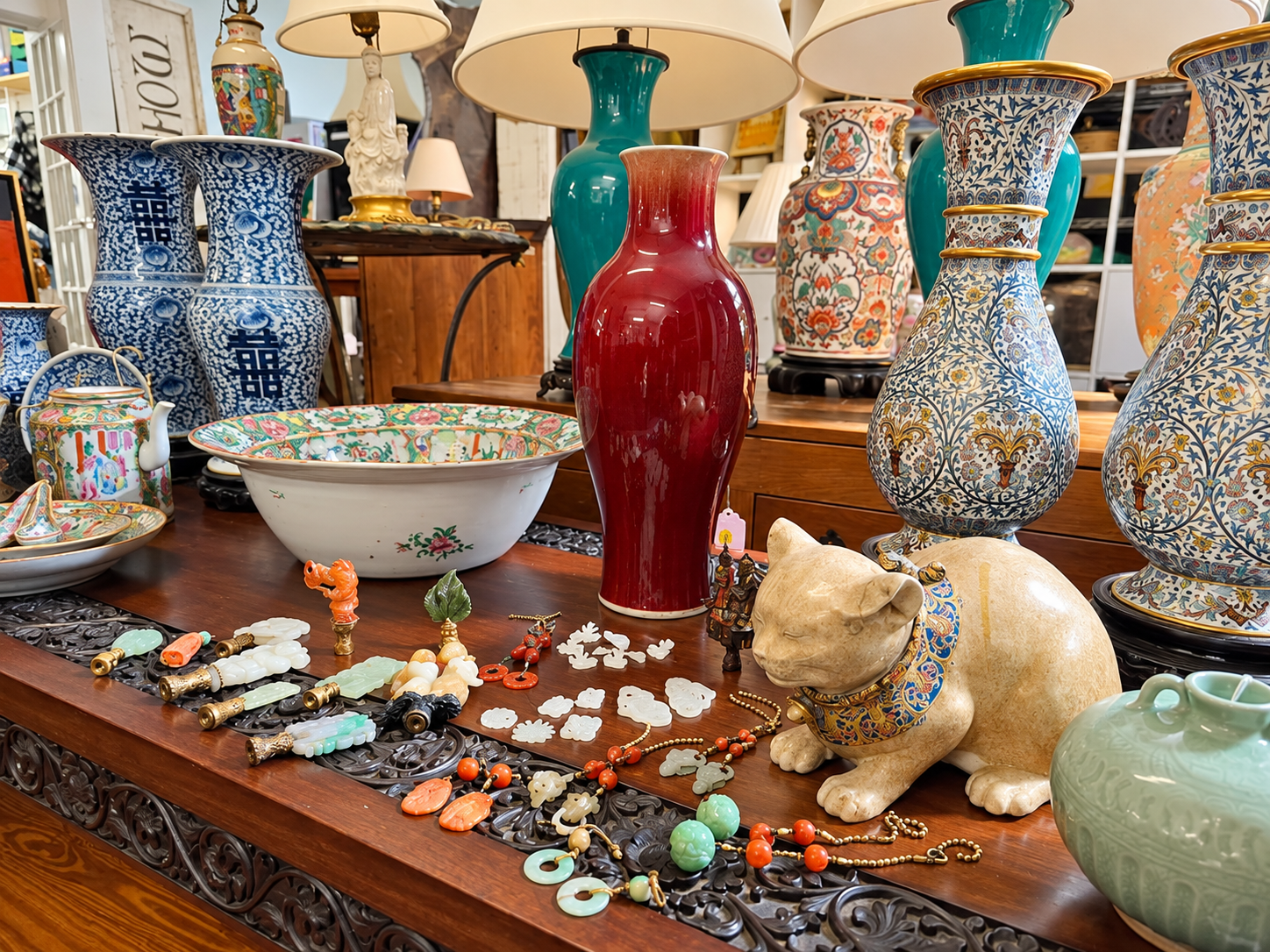 Display of Asian antiques, jade carvings, jewelry, and decorative ceramics at East-Wing’s Oakville gallery.