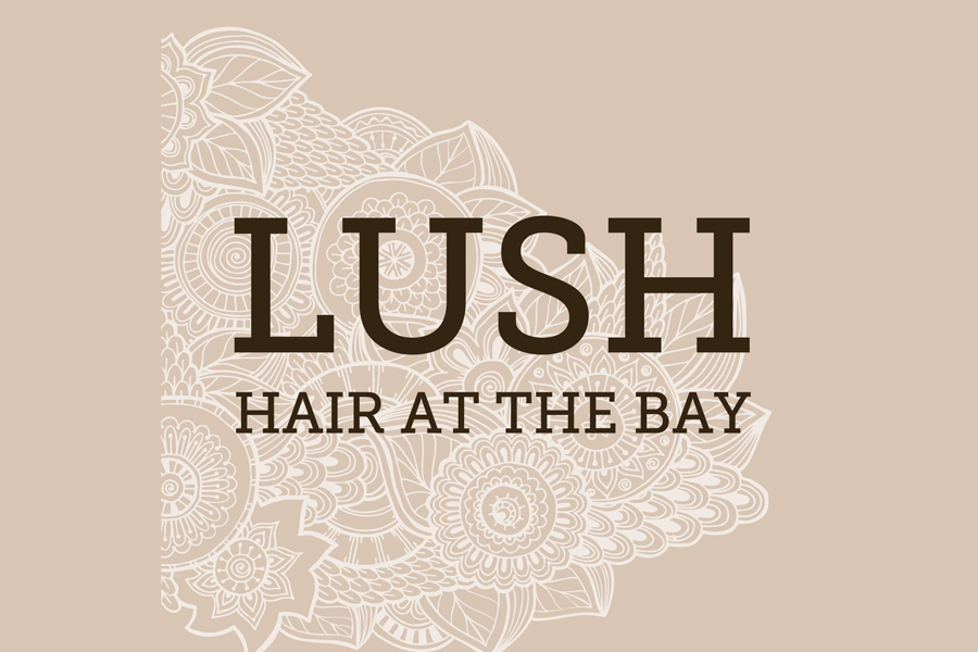 Logo for Lush Hair at the Bay with a beige background and intricate white floral patterns.