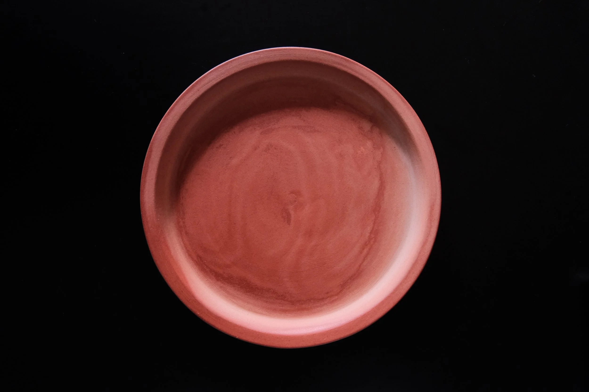 Japanese ceramic bowl plate in dyed red color and black background - 2026 tableware collaboration made by Shiga Nota_shop x Hender Scheme.