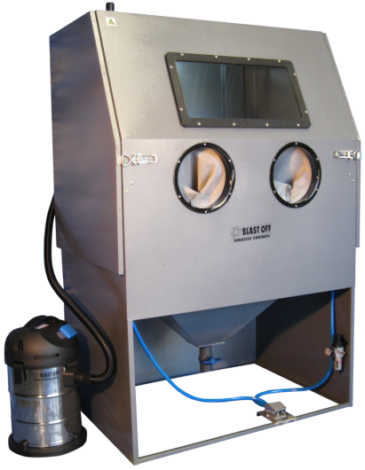 A blast cabinet with two circular viewing windows and a rectangular window on top, equipped with a vacuum system for cleaning or surface preparation.