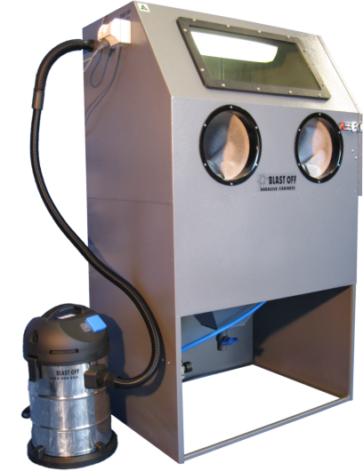 A large industrial sandblasting cabinet with gloves and a vacuum system for cleaning or finishing worker gloves