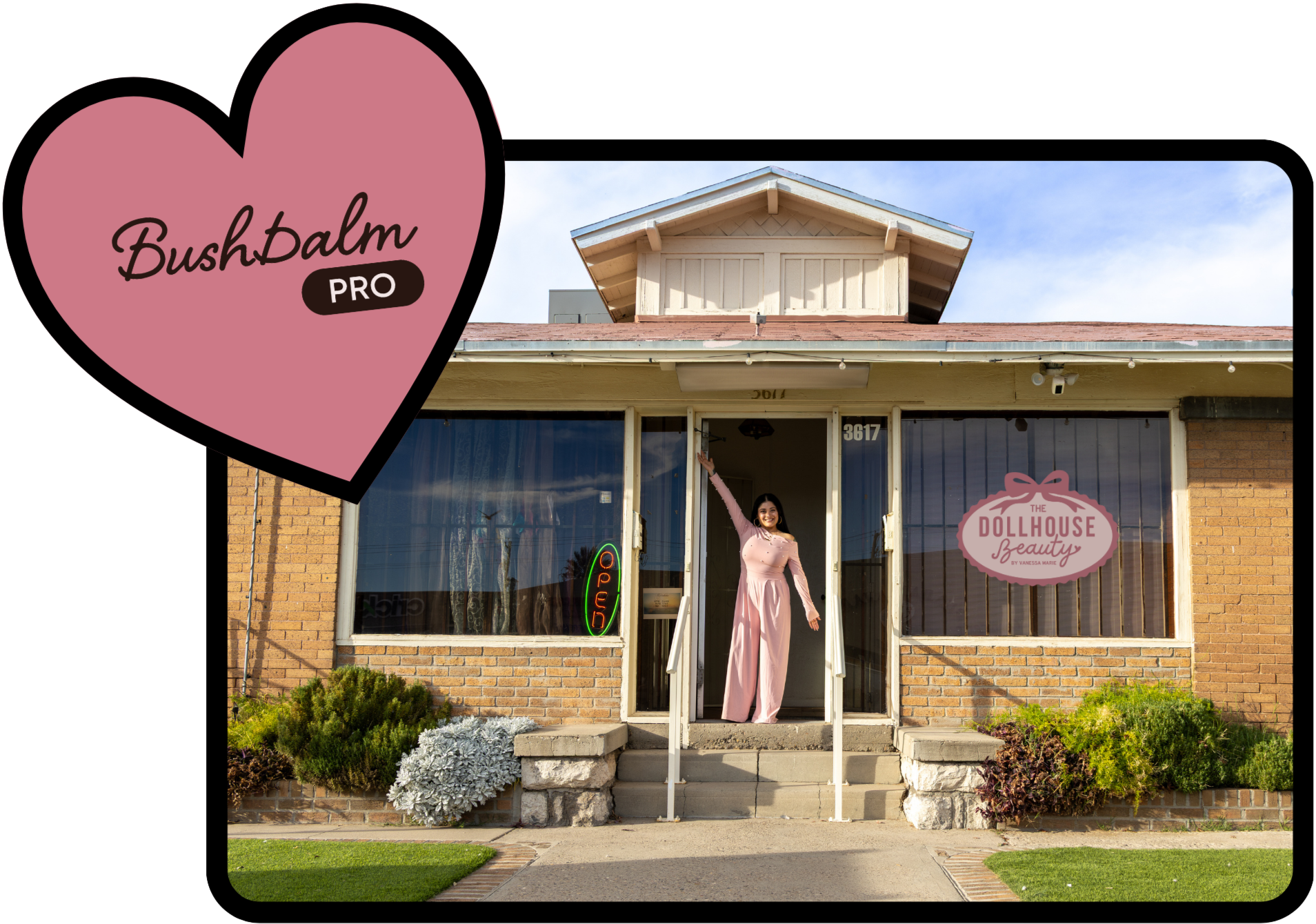 A woman in a pink dress standing at the entrance of a small brick shop with a glass door and windows, a sign that says "The Dollhouse Beauty by Vanessa Marie," and a pink heart-shaped logo with "BushBalm PRO" written inside. The shop has outdoor stairs, a small garden with plants, and a bright, clear sky