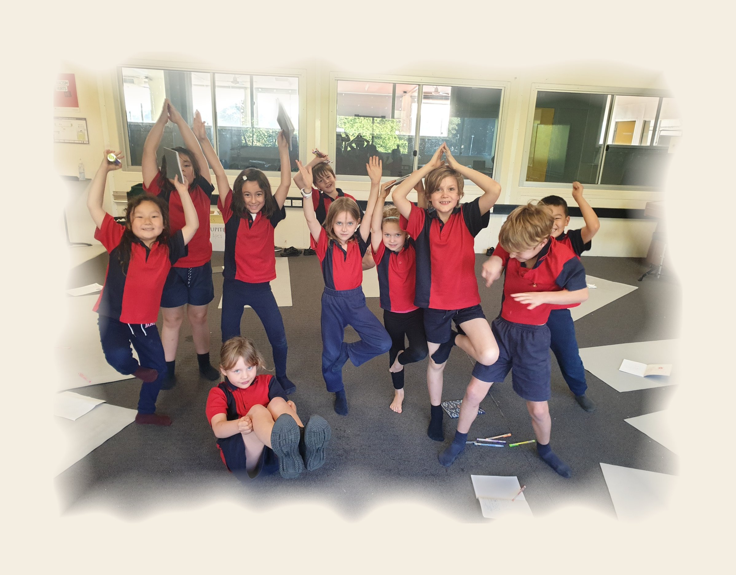 Children practising yoga together at Alexandria Park Community School
