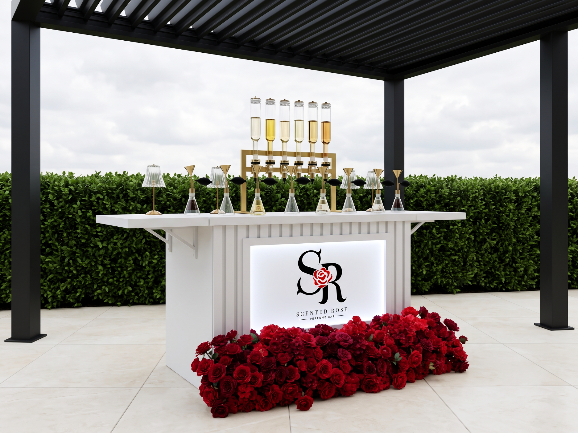 A perfume display at a scented rose perfume bar with a white counter, surrounded by red roses, with vials of perfume and a logo featuring a stylized rose and the words "SCENTED ROSE PERFUME BAR."