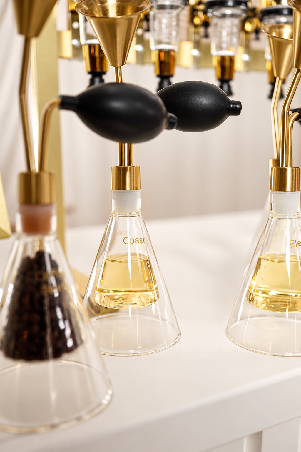 Close-up of perfume fragrance testing bottles with brass atomizer pumps and black rubber bulbs