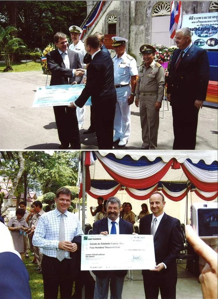 Two scenes of award and check presentation ceremonies outdoors. The top scene shows men in military and formal military uniforms exchanging a large check, with a decorated building in the background. The bottom scene shows three men in formal attire holding a large check, under a tent with red, white, and blue drapery, with other people in the background.