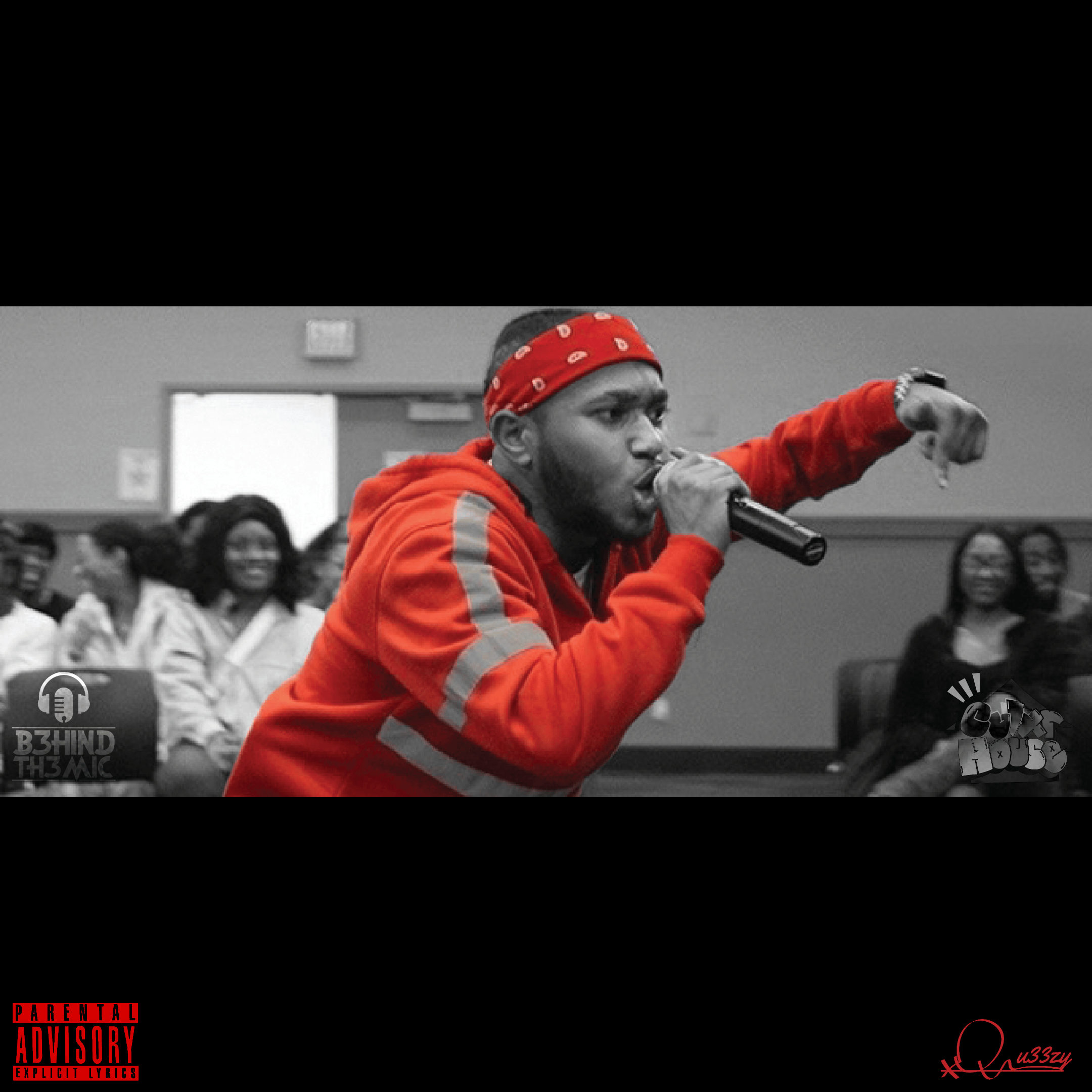 Qu33zy in a red bandana and hoodie performing into a microphone before a crowd