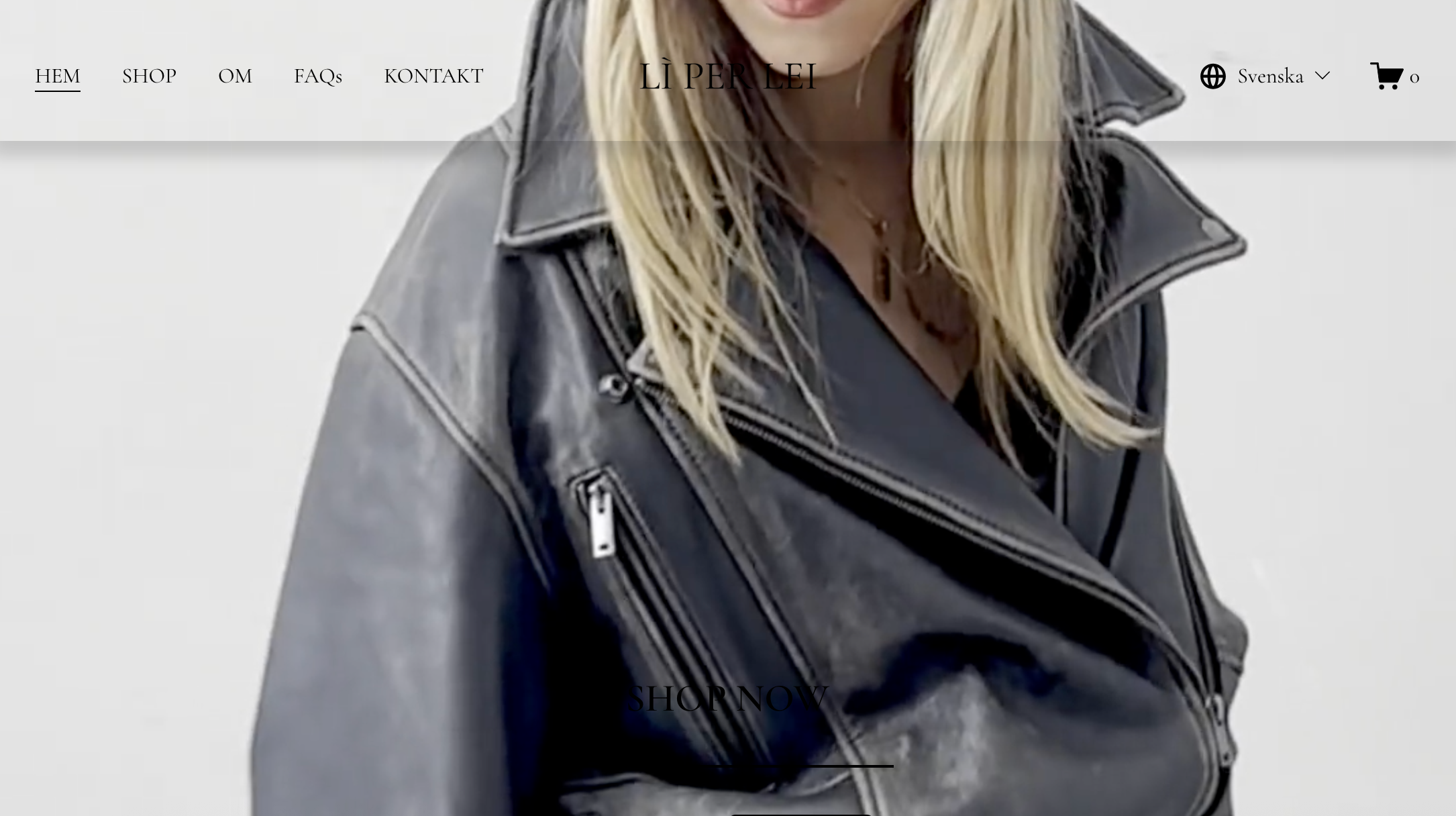 A woman wearing a black leather jacket, with blonde hair, smiling with a white background.