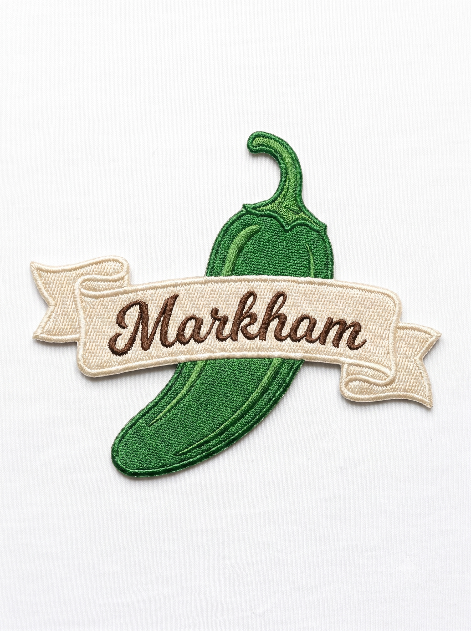 Embroidery patch with a green pickle and a beige banner reading 'Marshawn' on a white background.