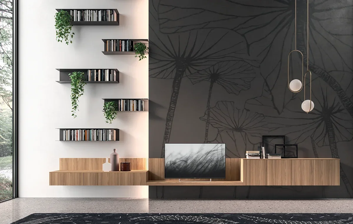 Modern living room with black and white wall art, floating shelves, a TV, decorative vases, books, and hanging pendant lights.