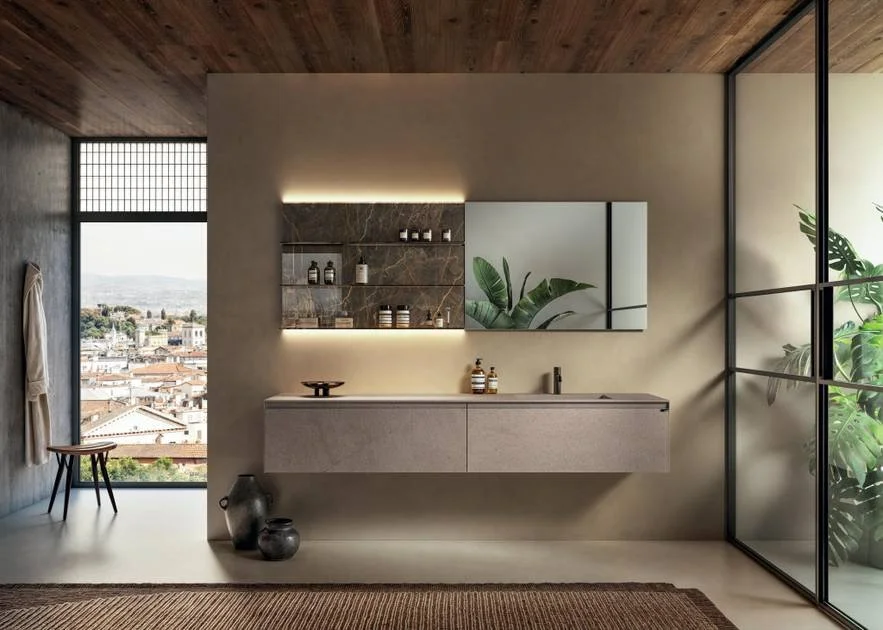 Modern bathroom with a floating vanity, large mirror, glass shelves, indoor plants, and a view of a city skyline through large windows.