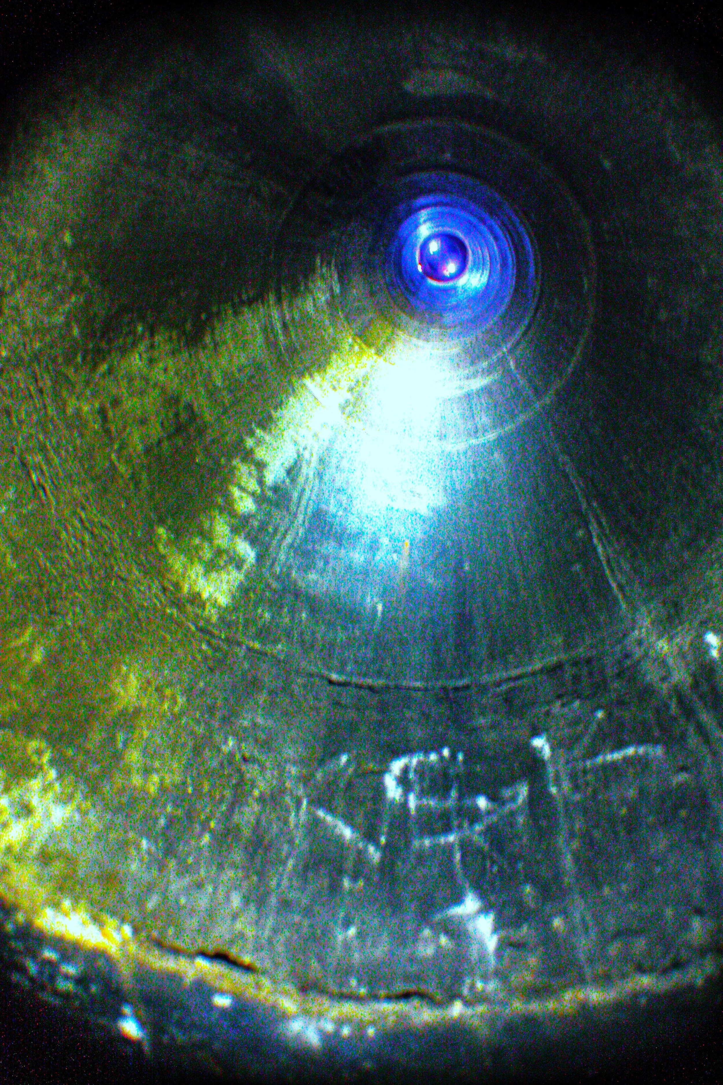 Close-up of a metallic surface with a circular pattern and a glowing blue center.