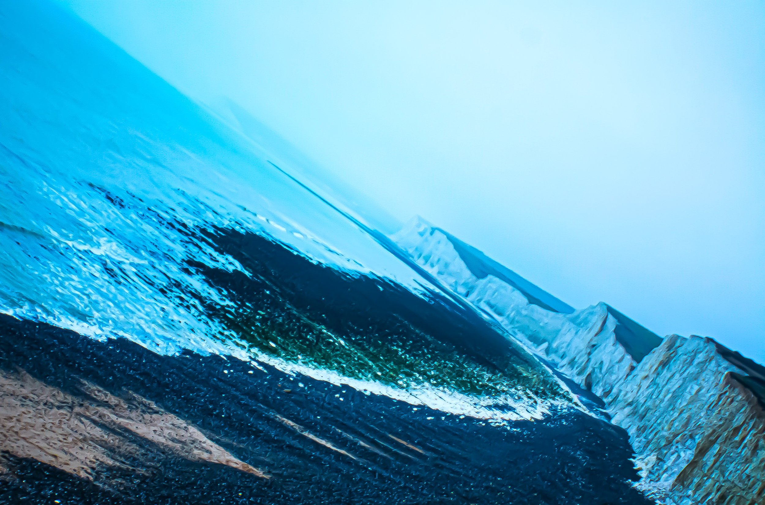 Close-up of a icy glacier with vivid blue ice formations and textured surface.