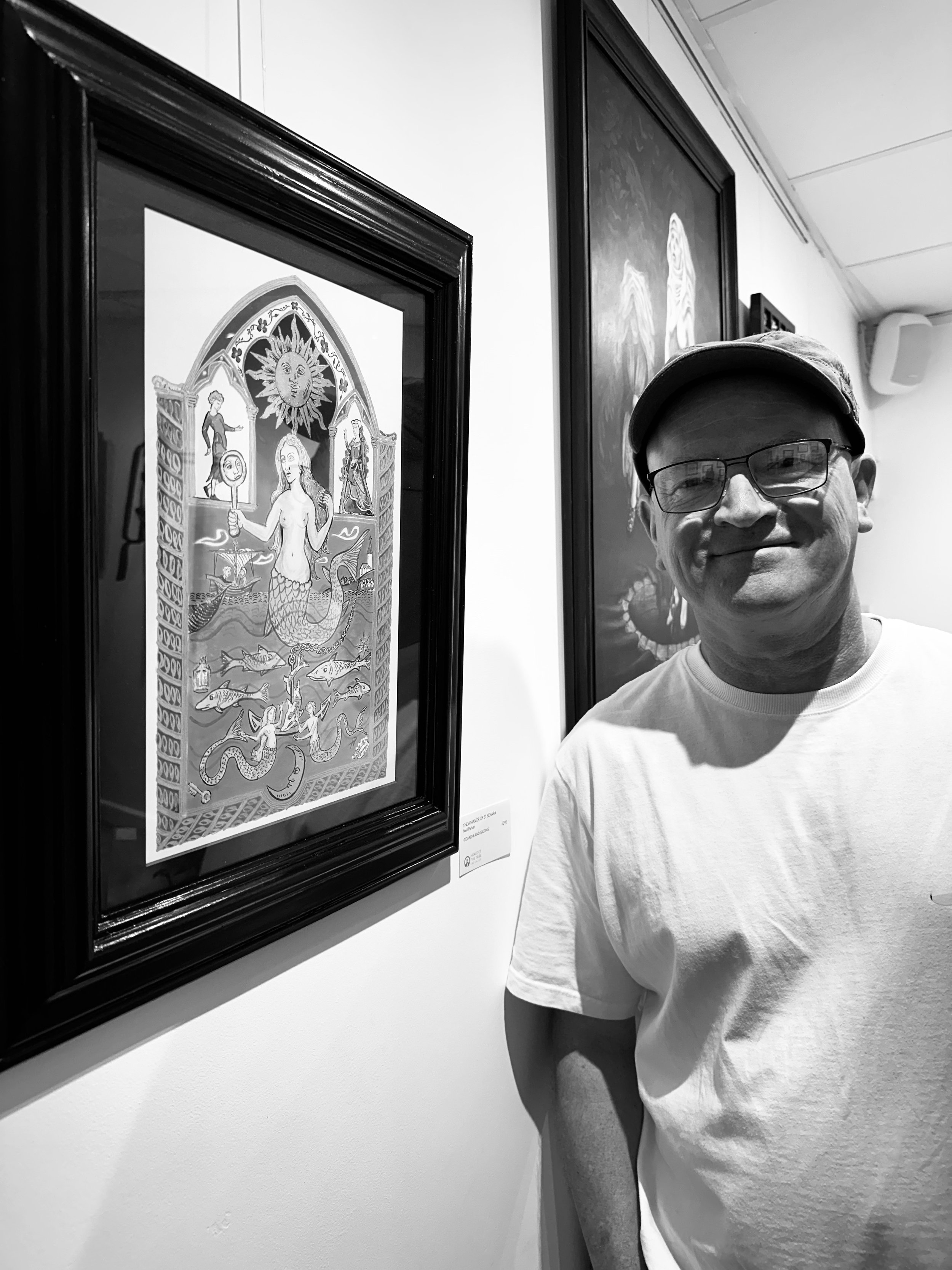 Neil Parker with his work 'The Athenor of St Senara' displayed on a gallery wall.