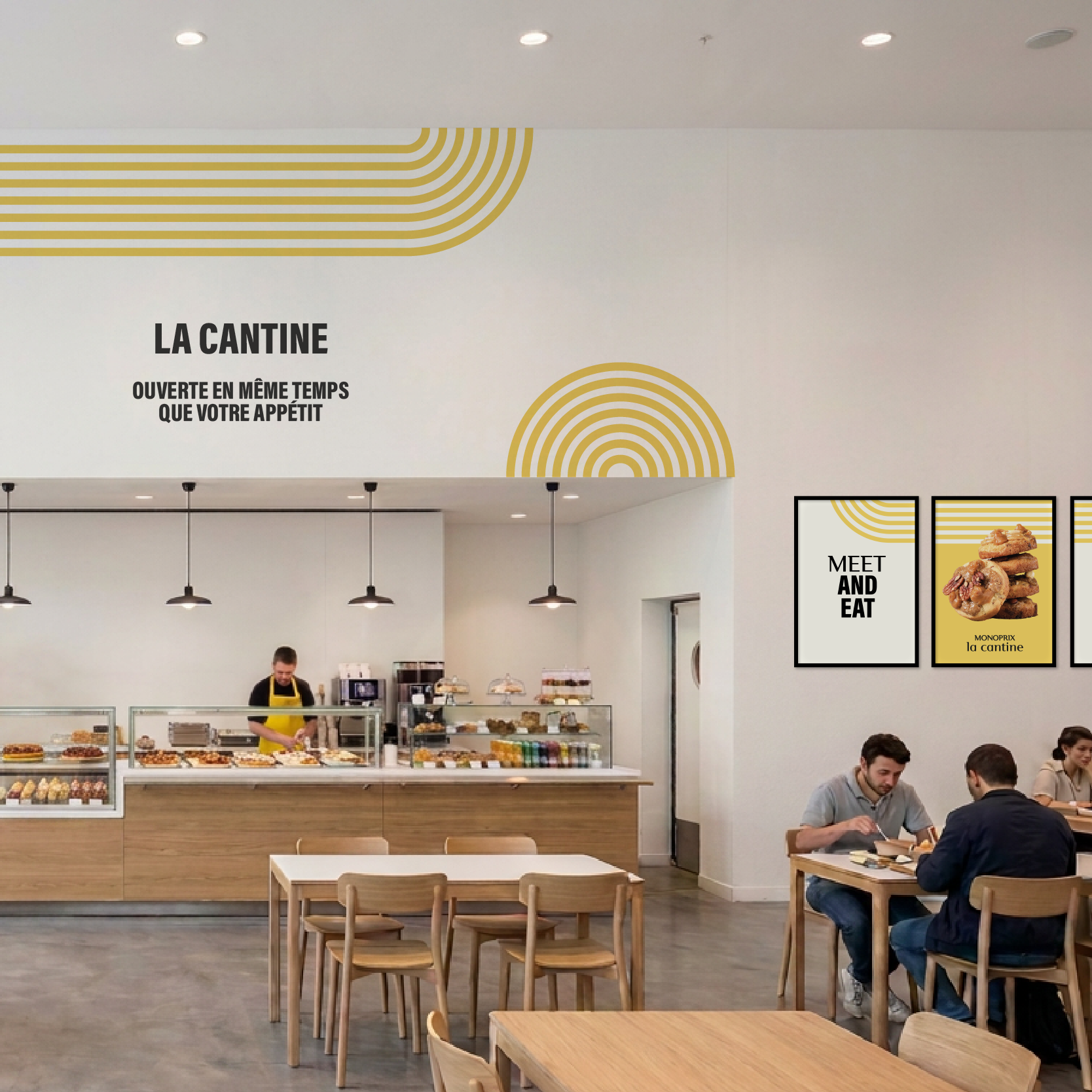 Intérieur de la cantine Monoprix, fresque murale d'arcs jaunes, signalétique « La cantine » et cadres de la marque, identité et signalétique de point de vente