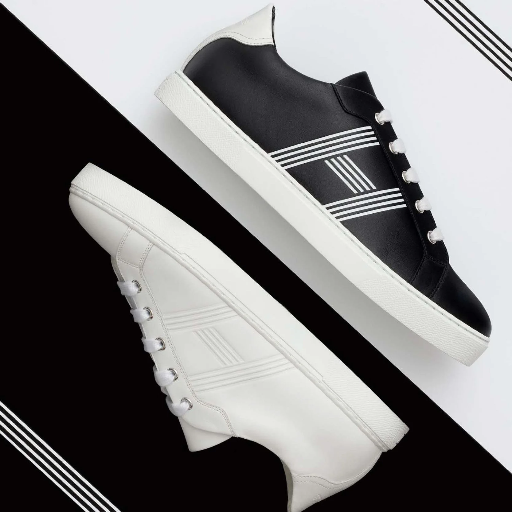 Sneakers Hermès noire et blanche photographiées en diagonale sur fond noir et blanc, lignes parallèles, direction artistique image formation chaussure