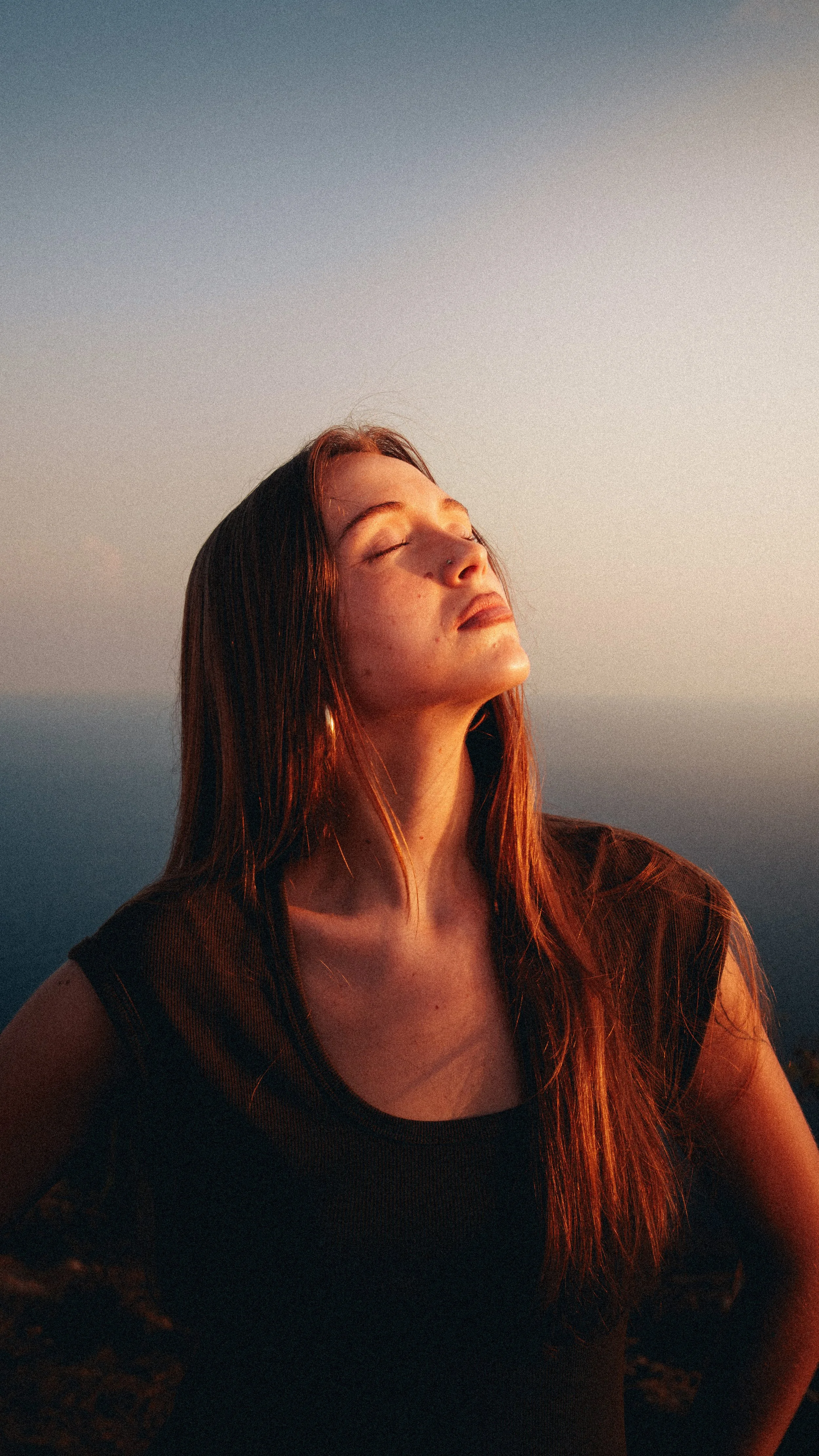 Woman posing in warm sunlight during a lifestyle brand photoshoot in Malta