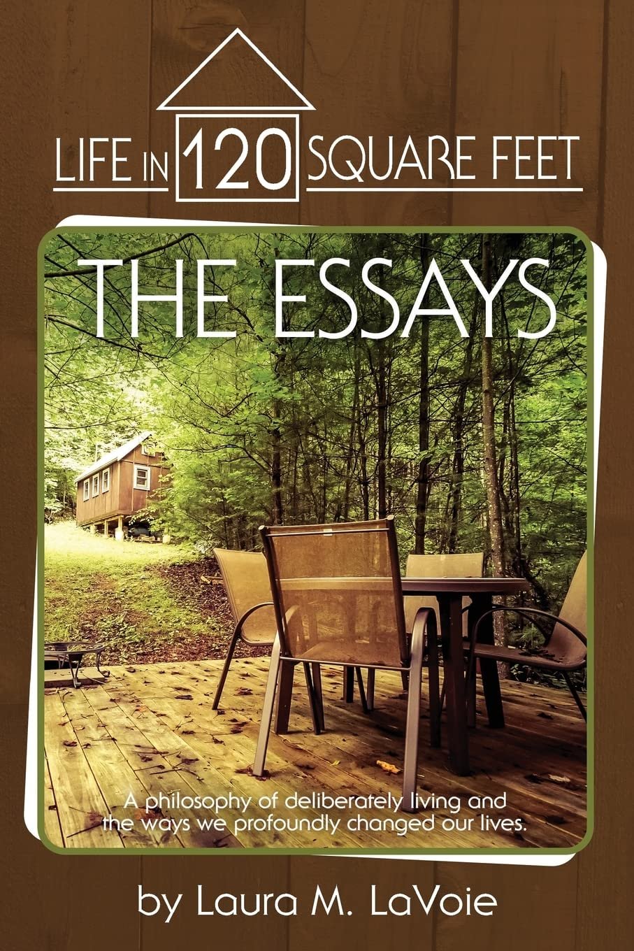 Book cover titled 'Life in 120 Square Feet: The Essays' by Laura M. LaVoie. Features a wooden deck with a table and chairs in a forest setting, with a tiny house in the background.