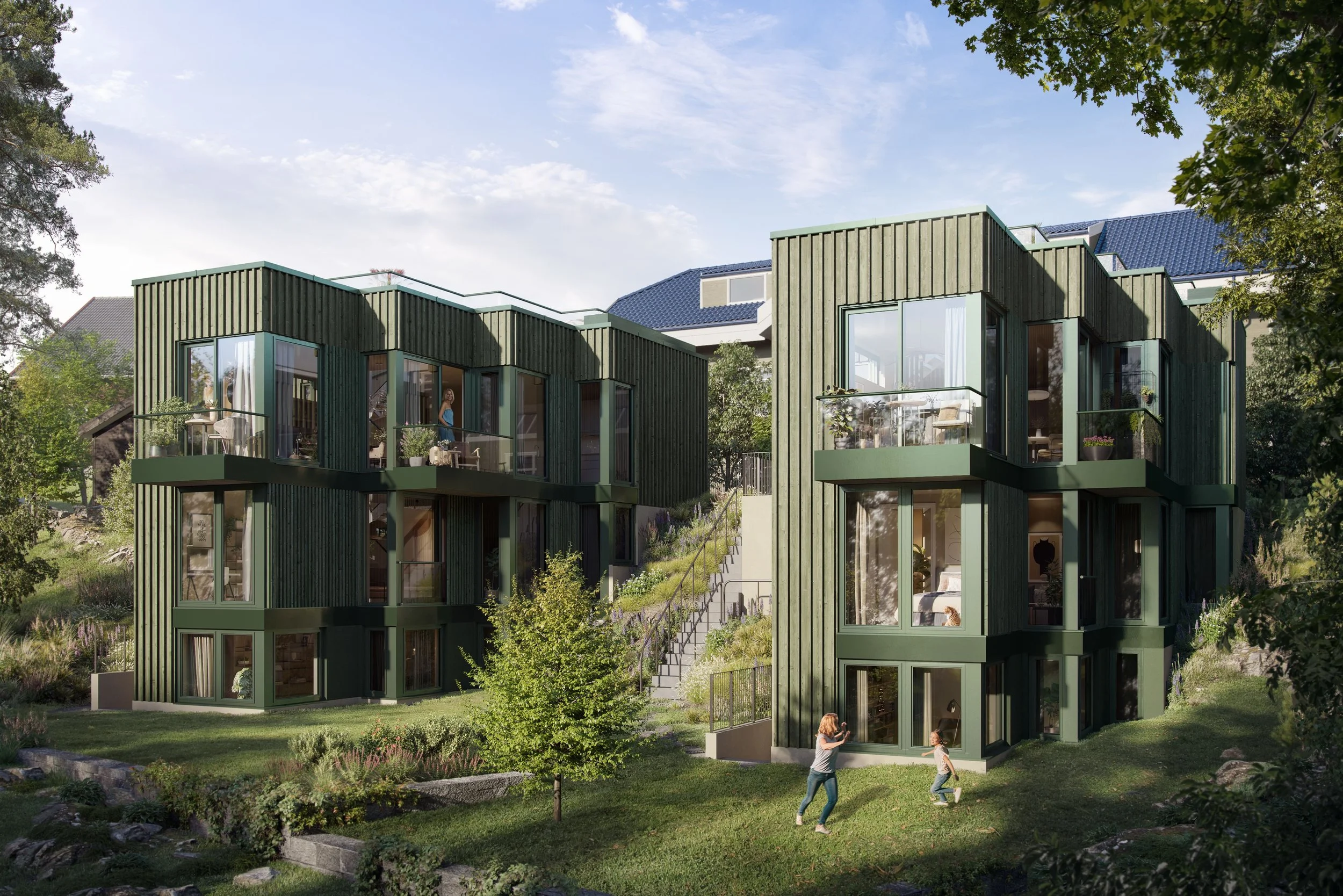 Modern green wooden multi-story townhouse with large glass windows and rooftop terraces, surrounded by lush greenery, with two women and a young girl outside, and trees framing the scene under a blue sky with clouds.