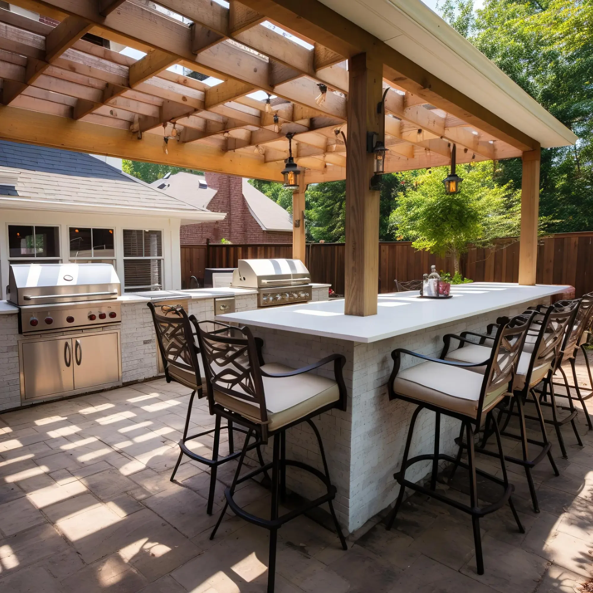 Under construction patio cover with wooden beams, string lights, outdoor kitchen, and patio furniture, surrounded by green trees.