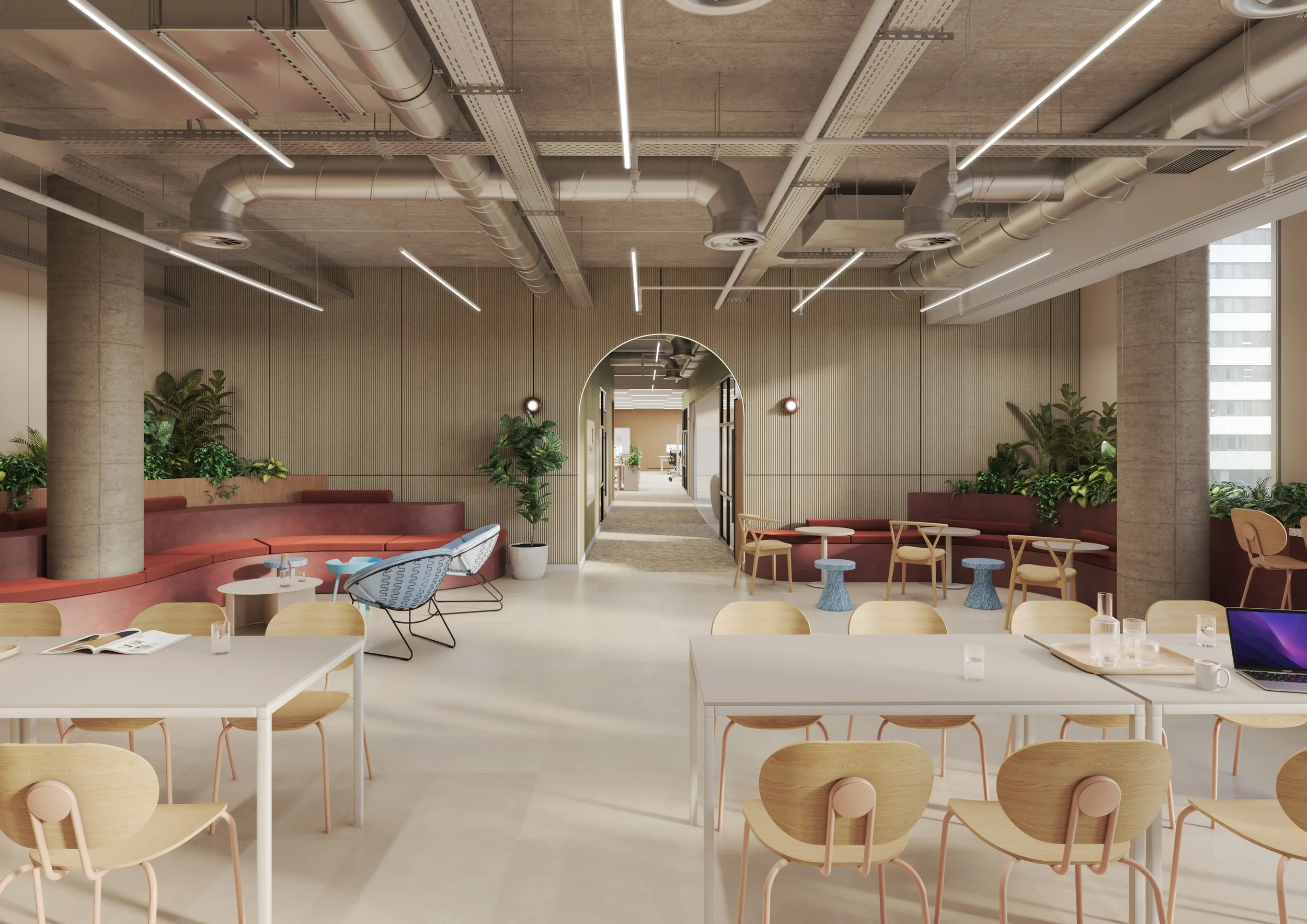 A modern office lounge area with round tables, wooden chairs, and beige couches. The space features large windows, indoor plants, and a hallway with an archway leading to additional rooms. The ceiling has exposed ductwork and linear lighting.