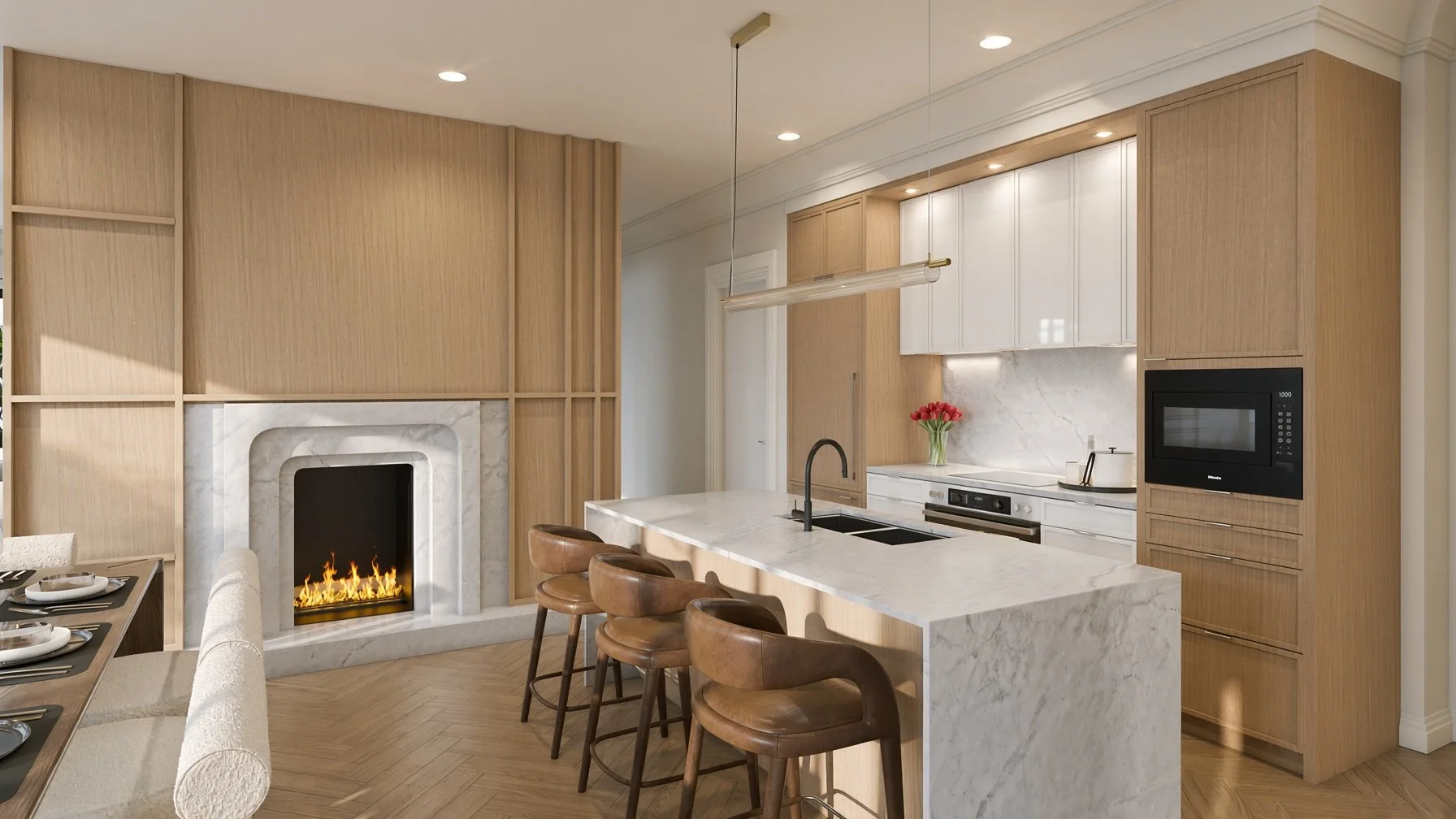 Modern kitchen with a white marble island, built-in oven, microwave, and a fireplace with a marble surround, wood accents, and a vase of flowers.