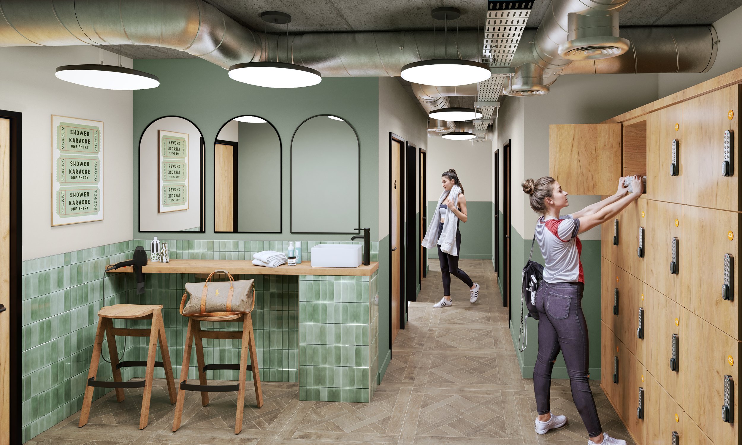 A locker room with two women, one using lockers and the other looking at her phone. The room has wood lockers, round ceiling lights, a green-tiled counter, mirrors, and framed posters on the wall.