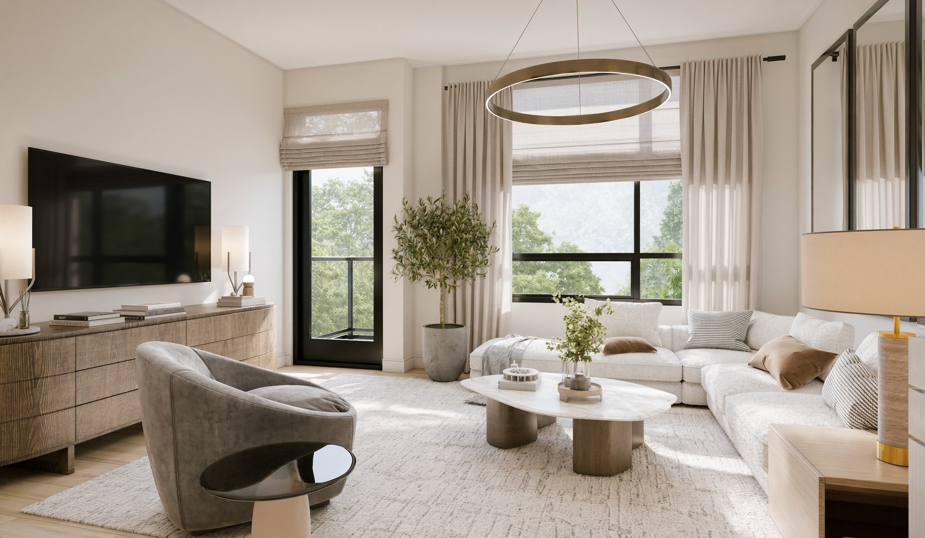 Bright living room with large windows, cream-colored sectional sofa, round marble coffee table, potted plant, and wall-mounted TV, decorated in neutral tones.
