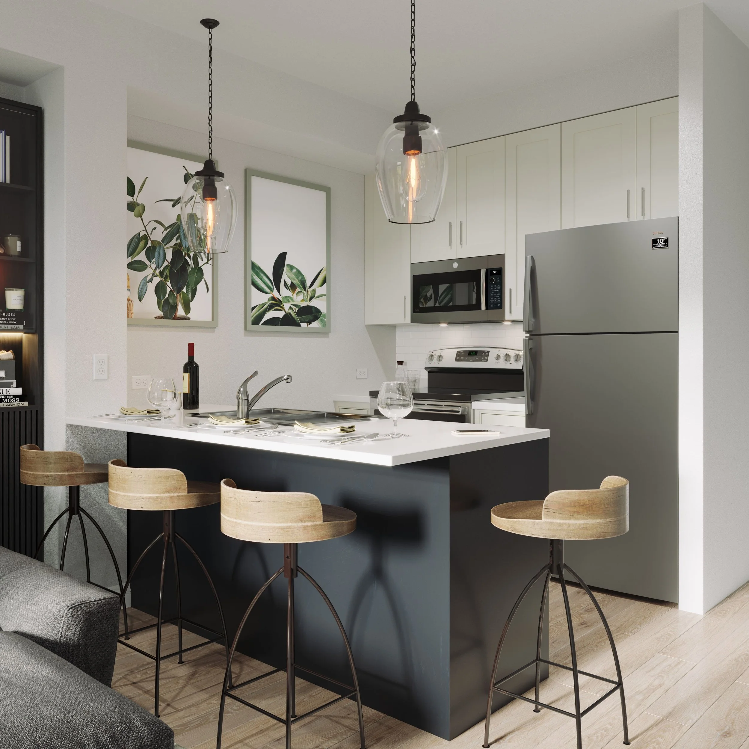 Modern kitchen with white cabinets, stainless steel refrigerator, microwave, and black kitchen island with bar stools, pendant lighting, and decorative wall art.