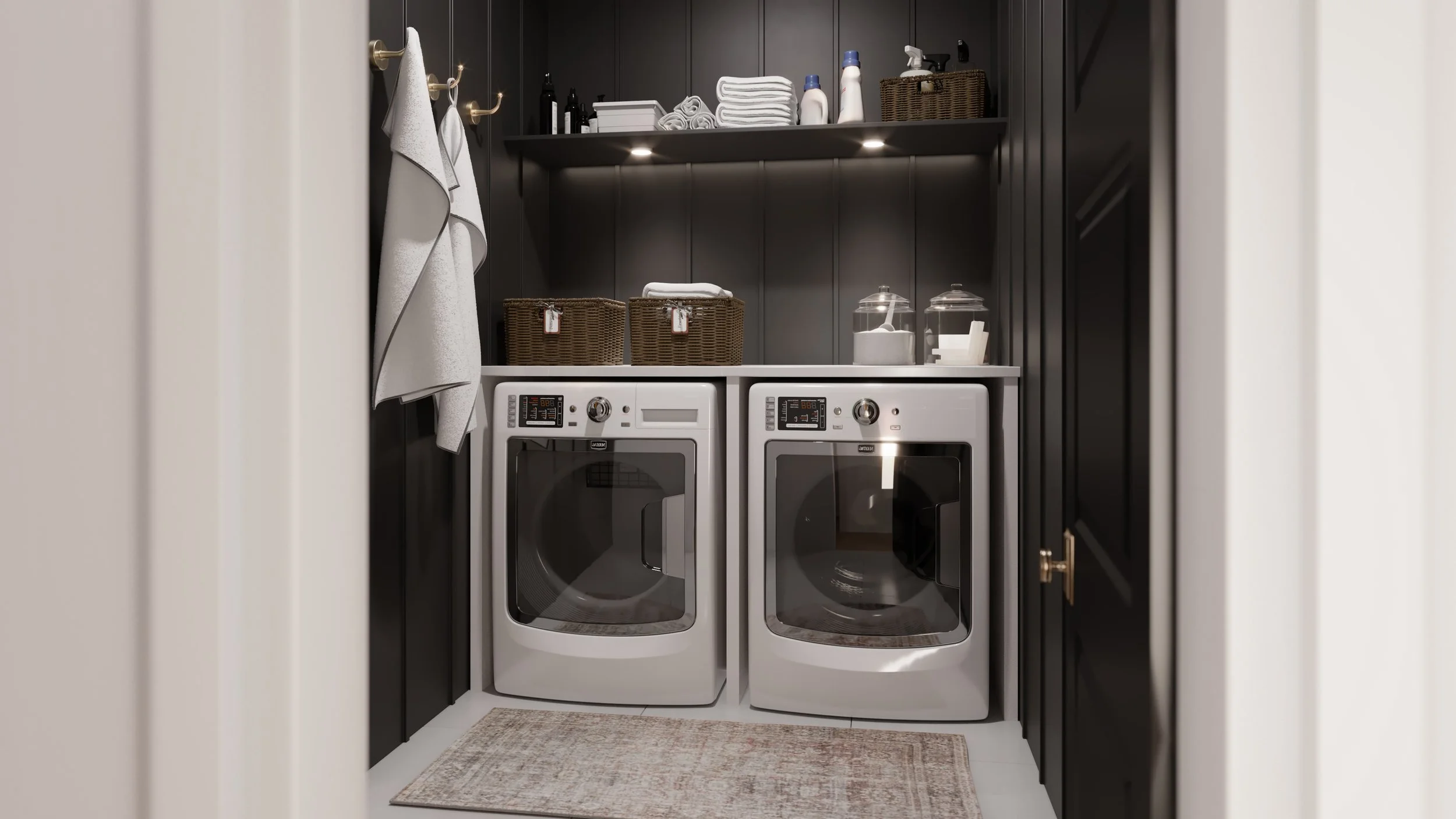 A laundry room with dark cabinets, white washing machines, and shelves holding towels, laundry detergent, and storage baskets.