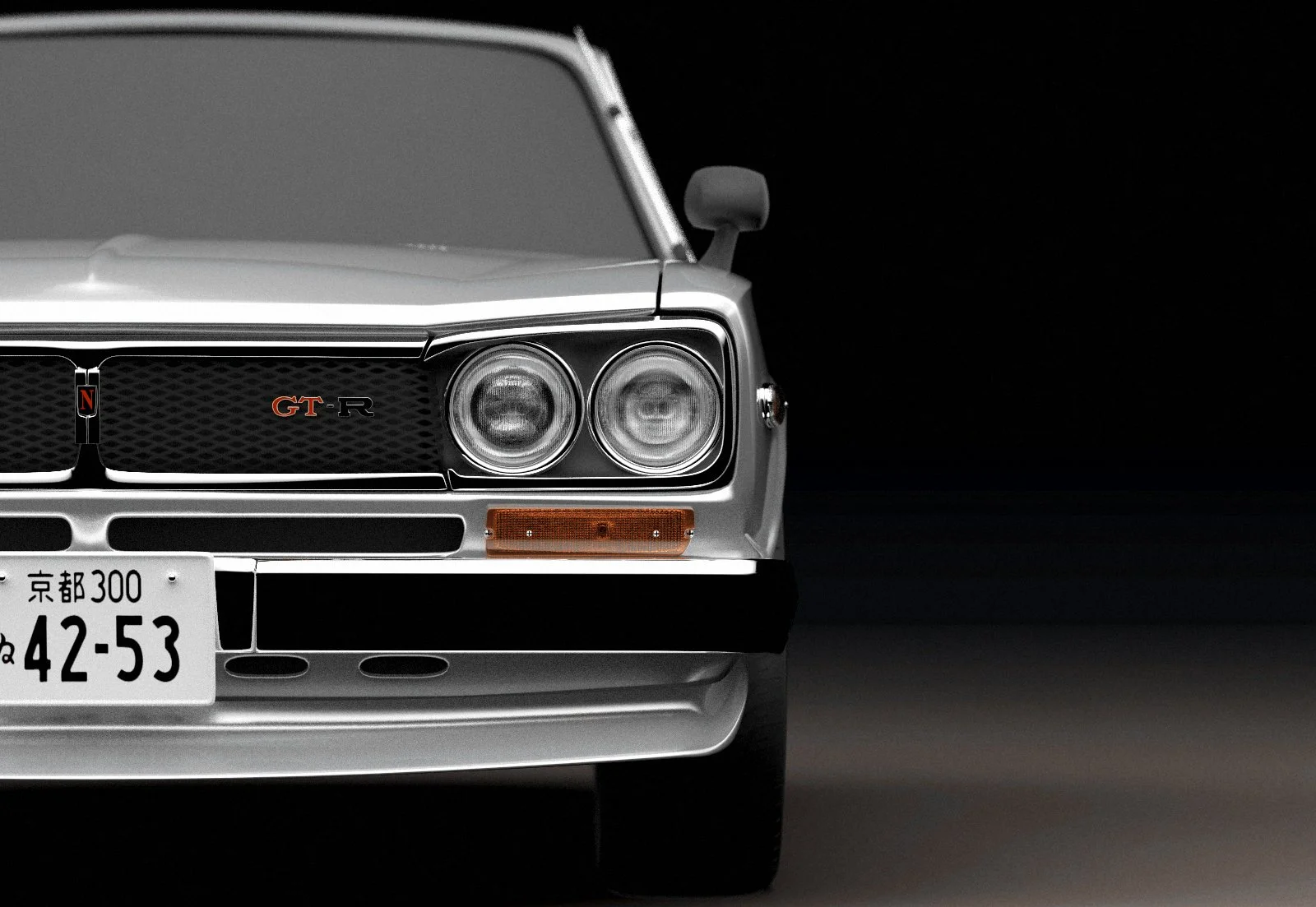 Front half of a silver classic Japanese car with dual headlights, black grille with 'GT-R' badge, Japanese license plate, and a dark background.