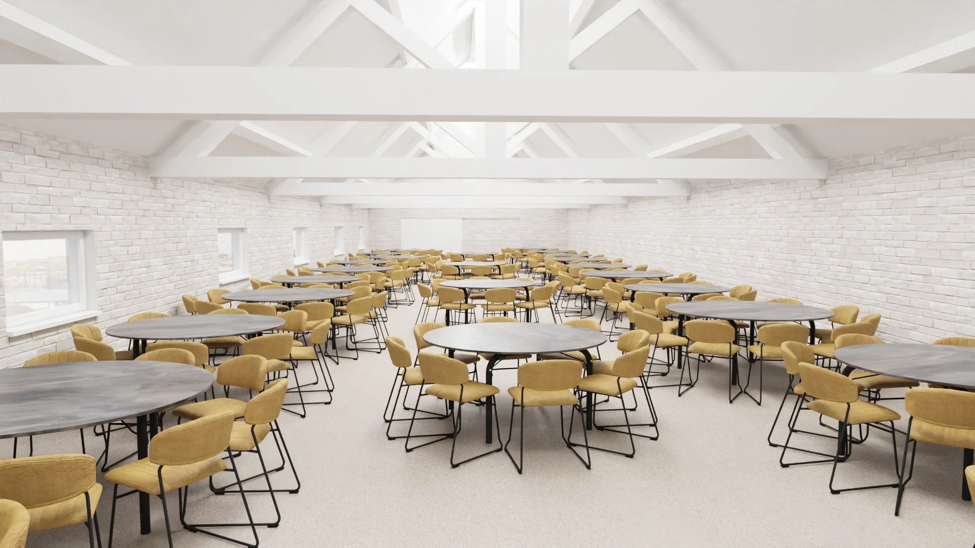 Large meeting or event room with white brick walls and skylight ceiling, filled with round tables and yellow upholstered chairs.