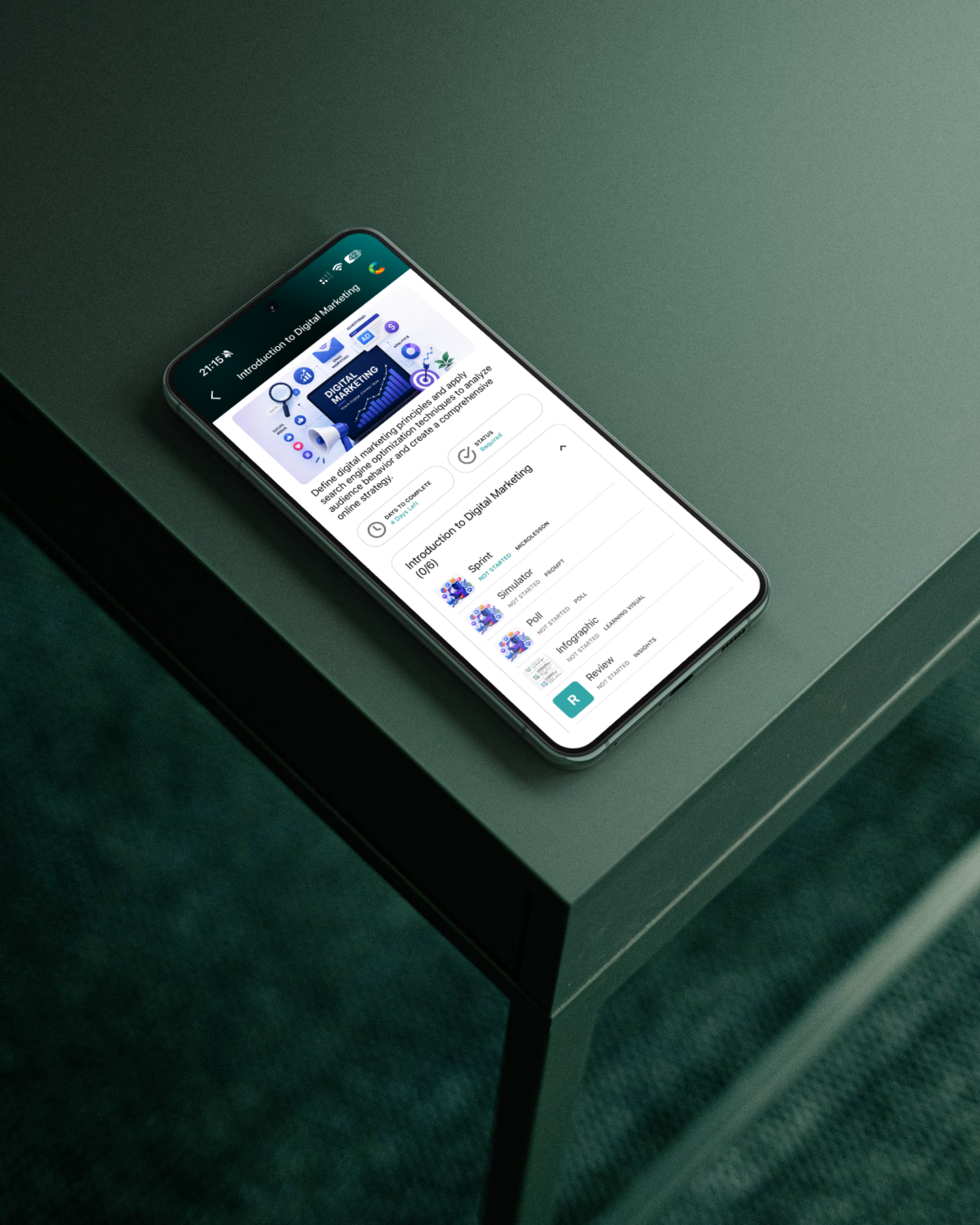 Close-up of a smartphone on a green table displaying an online course titled 'Introduction to Digital Marketing' with course modules listed below.