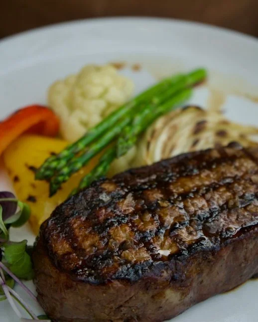 Grilled steak with grilled vegetables at Conversate Steak & Seafood.