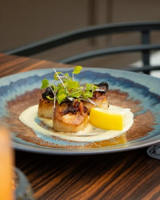 Scallops served on a creamy sauce at Conversate Steak & Seafood in Hamilton.
