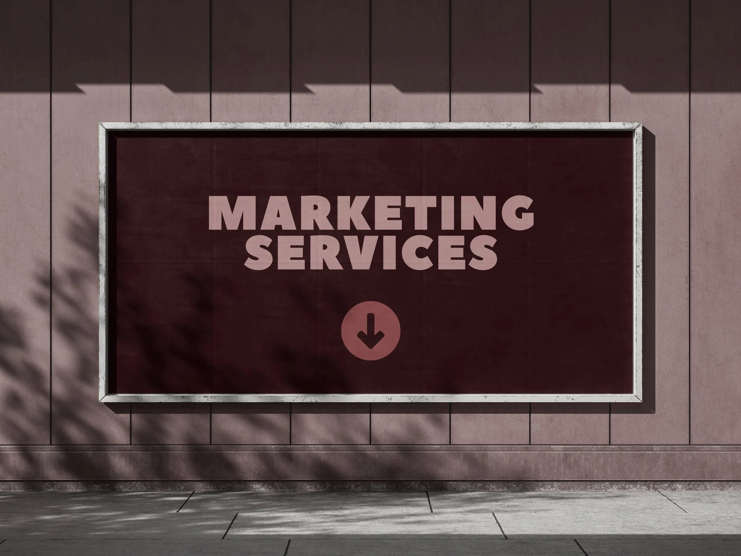 Signboard on a wall reading 'Marketing Services' with a downward arrow symbol.