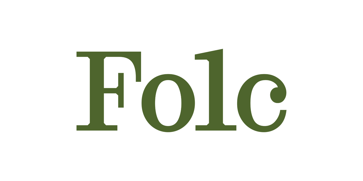 Text in a mirror image spelling 'Folk' in green font on a white background