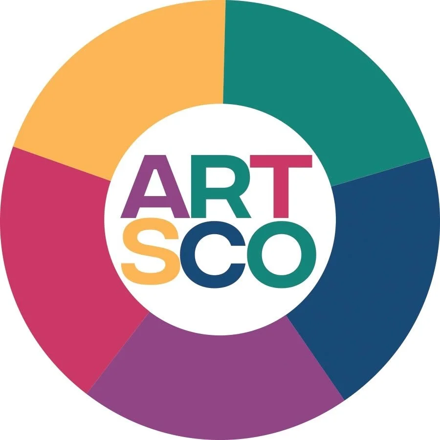 A colorful circular logo with the words "ART SCO" in the center, surrounded by various colored segments.