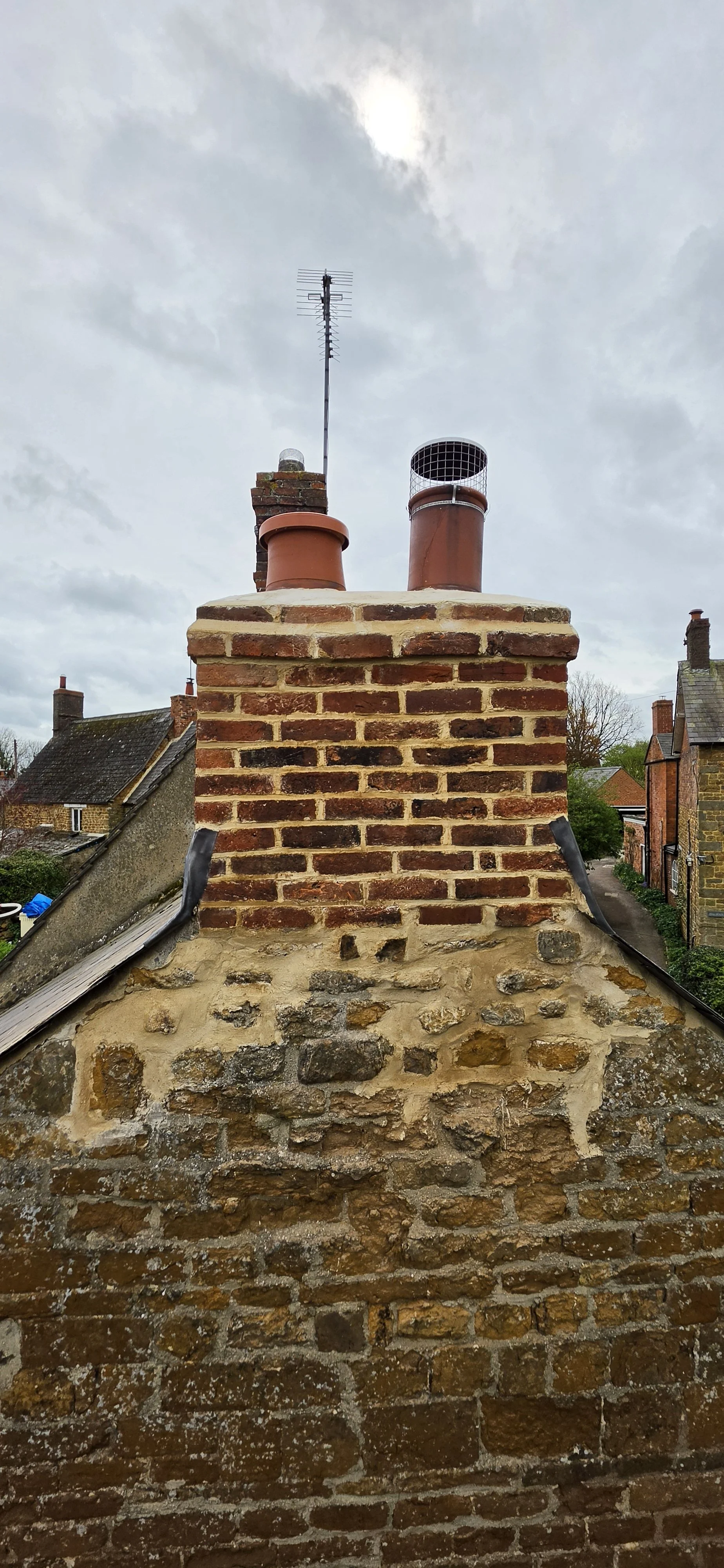 Rebuilt brick chimney stack on a stone cottage in Buckinghamshire