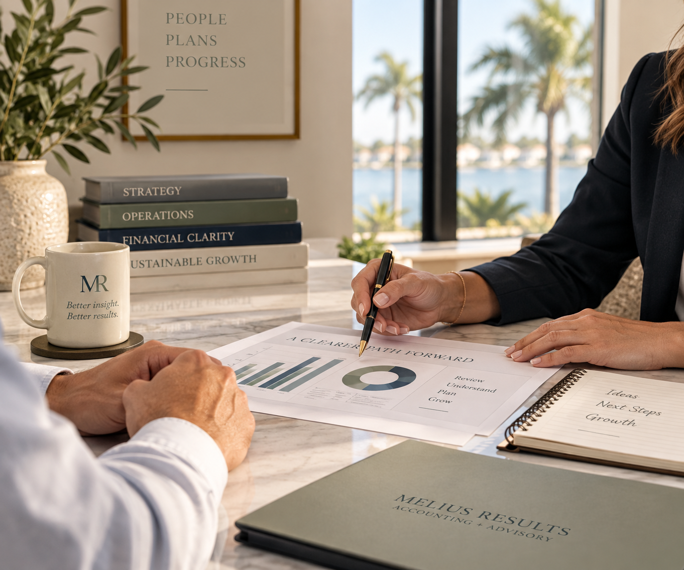 Business meeting reviewing financial reports in a professional waterfront office