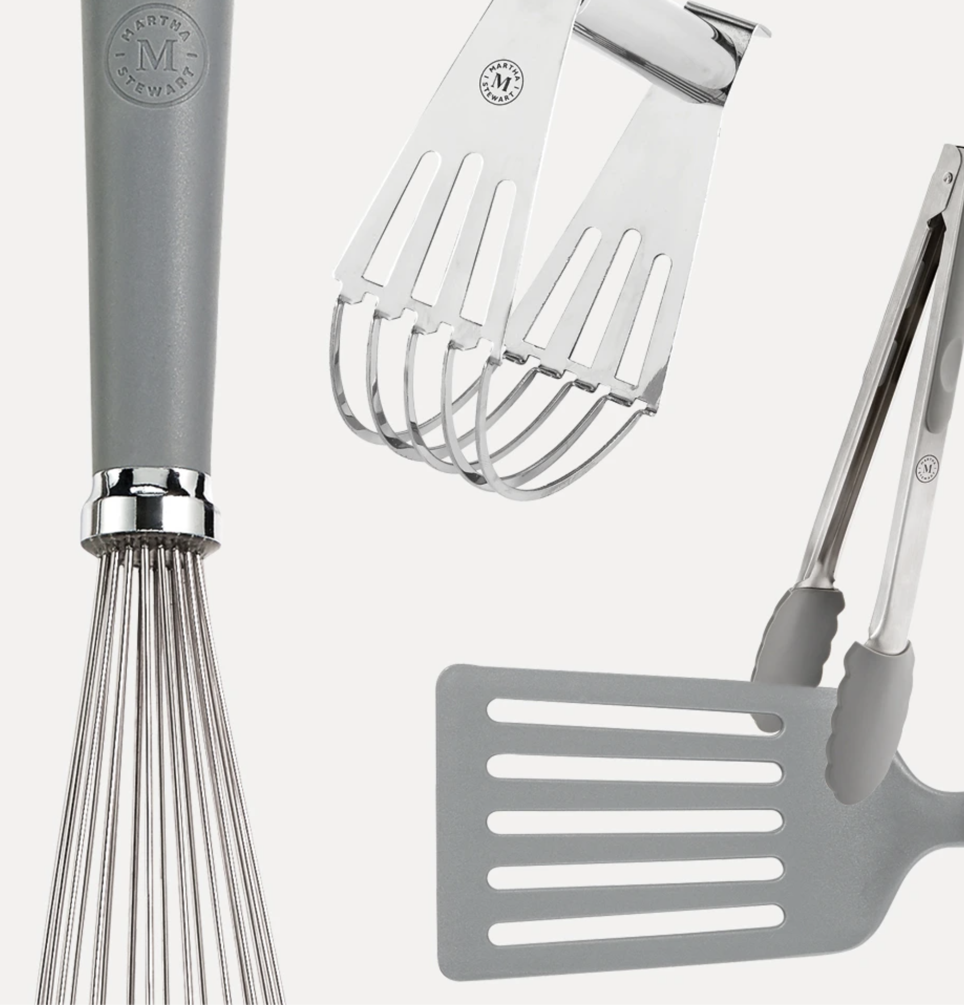 Close-up of a kitchen faucet, a metal dish drying rack with slotted design, and a grater, all in a modern kitchen setting.