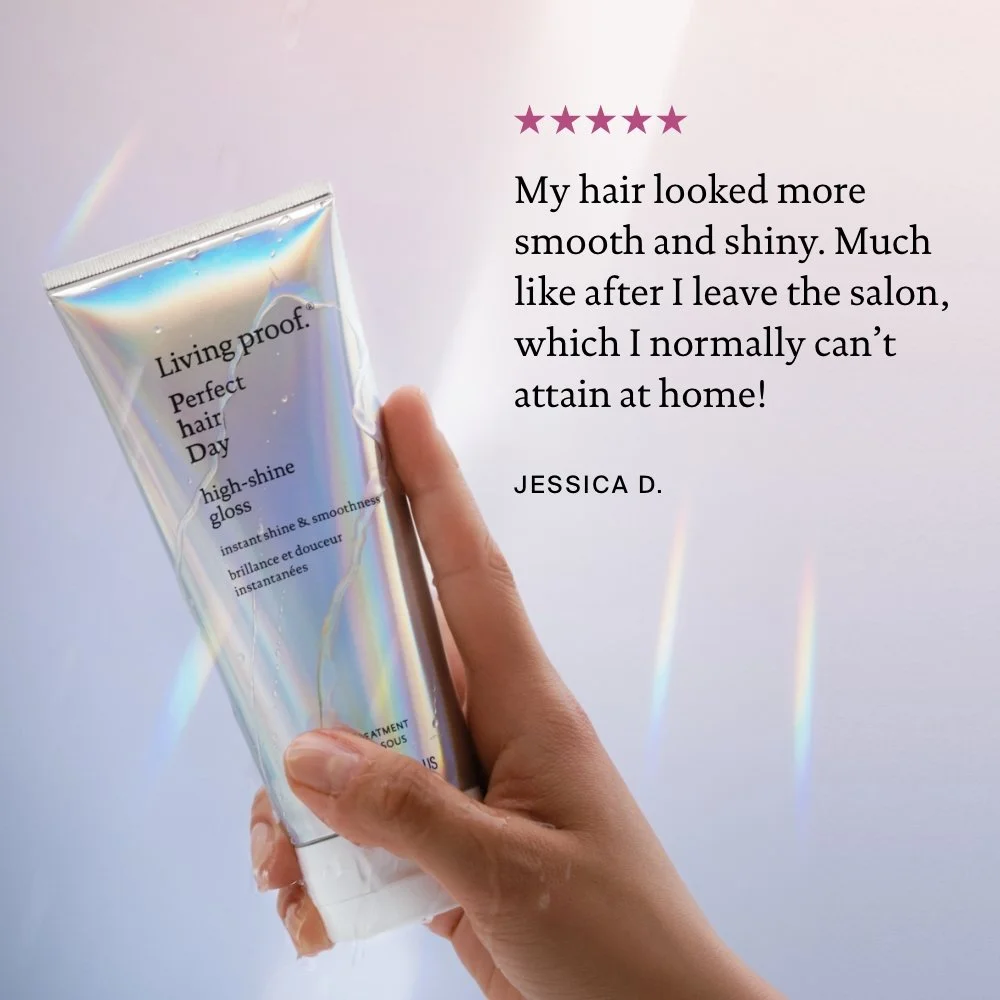 A hand holding a tube of Living Proof Perfect Hair Day high-shine gloss, with a pastel rainbow background. To the right, there is a customer review with four purple stars and a testimonial from Jessica D. praising the product for making her hair smooth and shiny like after leaving the salon.