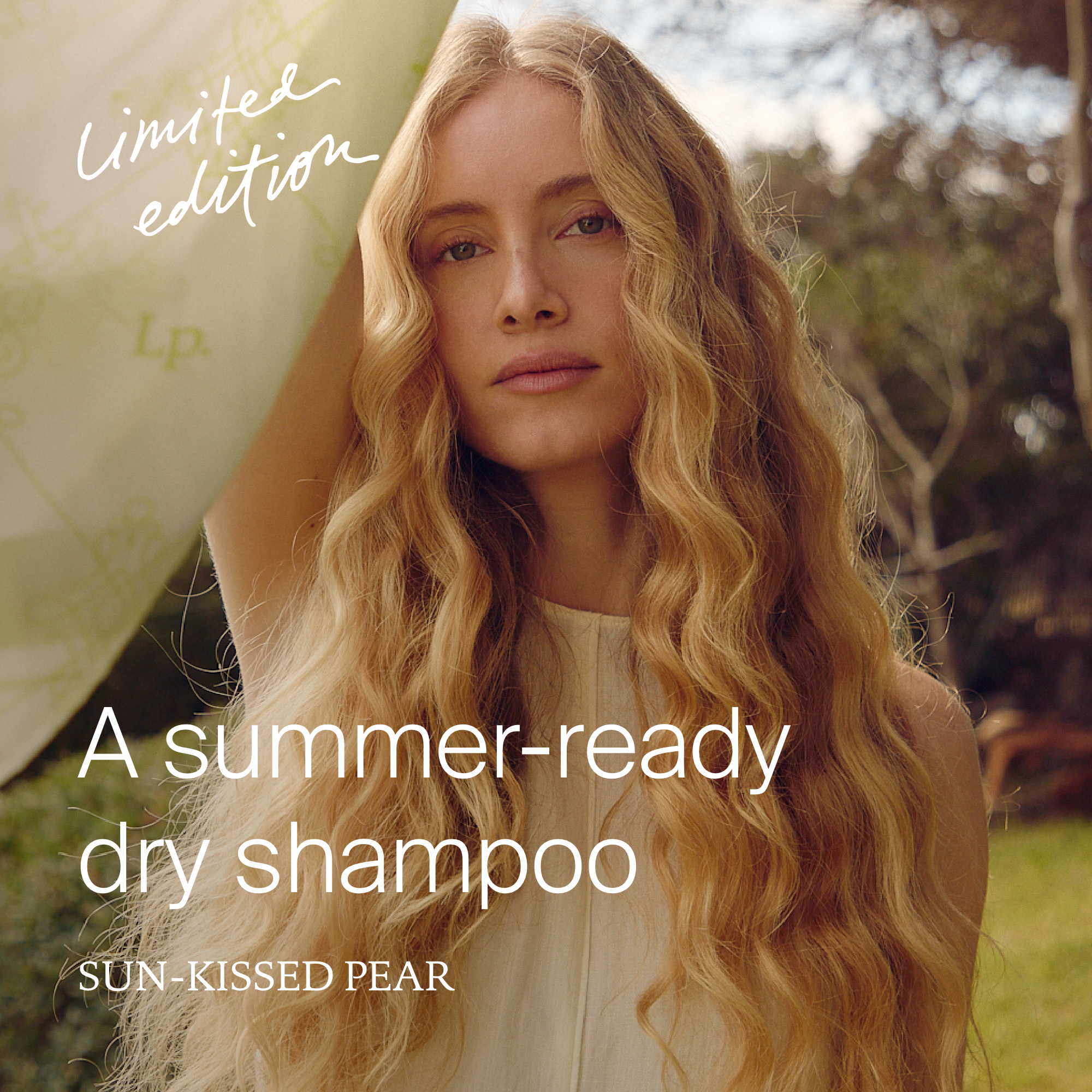 A woman with long blonde hair outdoors, looking at the camera, with the text 'Limited edition' and 'A summer-ready dry shampoo' overlaid.