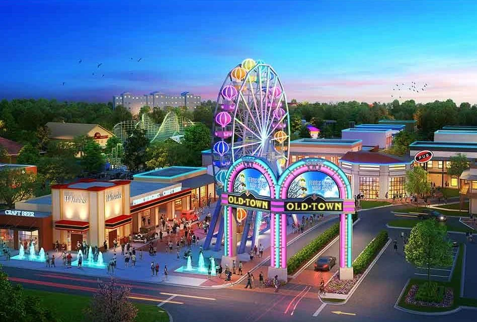 Old Town Kissimmee entertainment district with a Ferris wheel, fountains, and shops at sunset.
