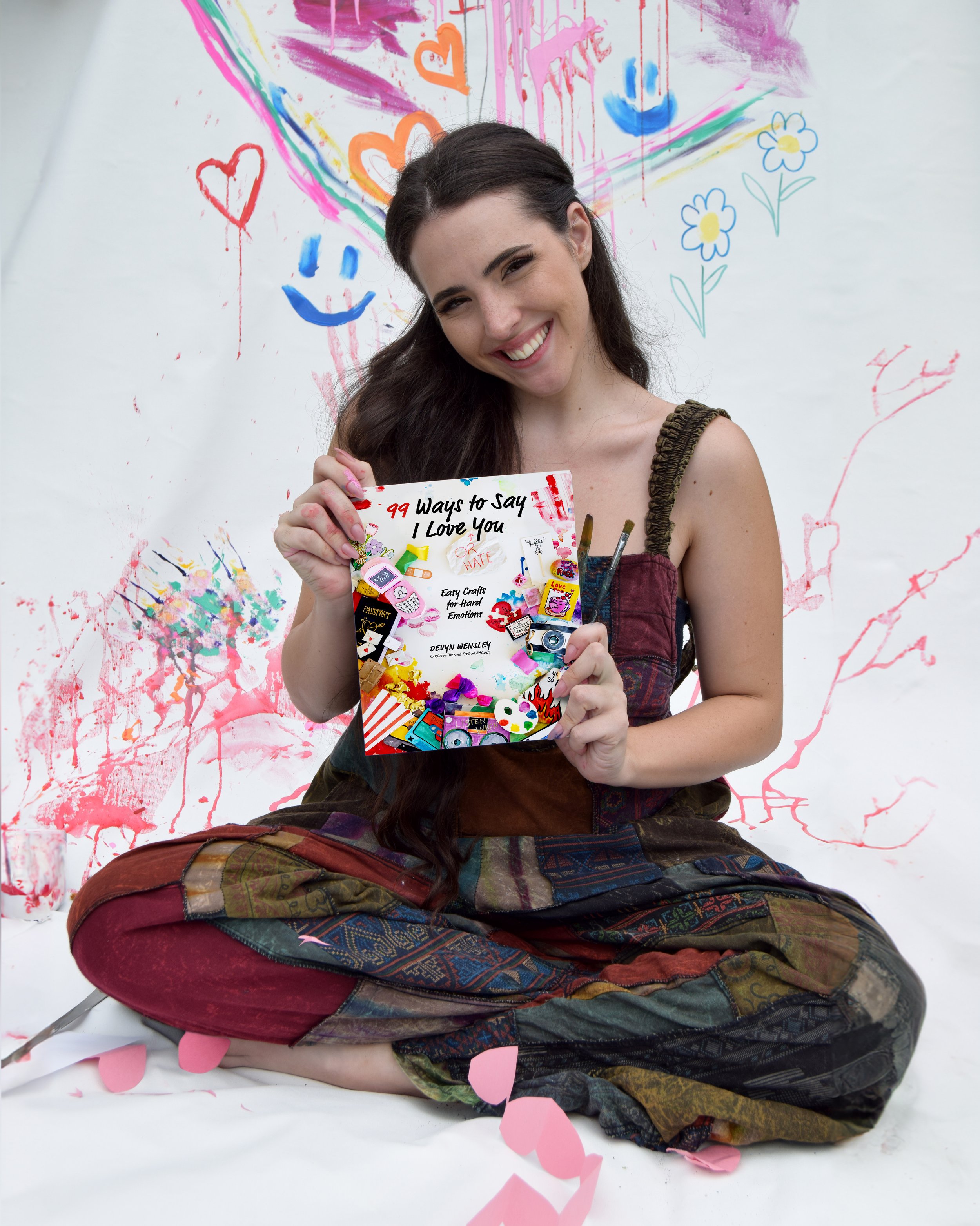 Devyn Wensley of StainedHands showing her book cover