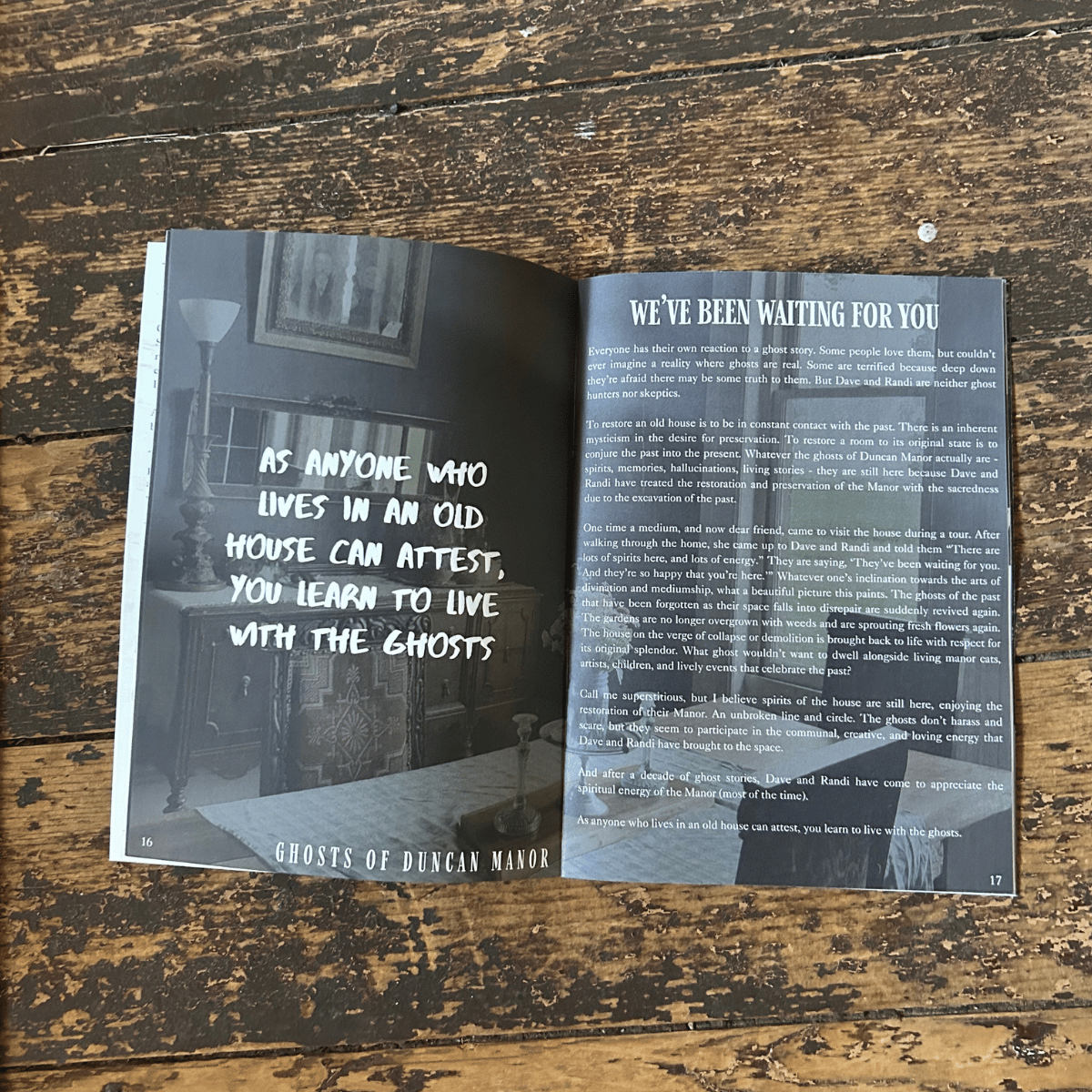 Open magazine showing pages about ghosts of Duncan Manor, with a quote: "As anyone who lives in an old house can attest, you learn to live with the ghosts." On a wooden surface.